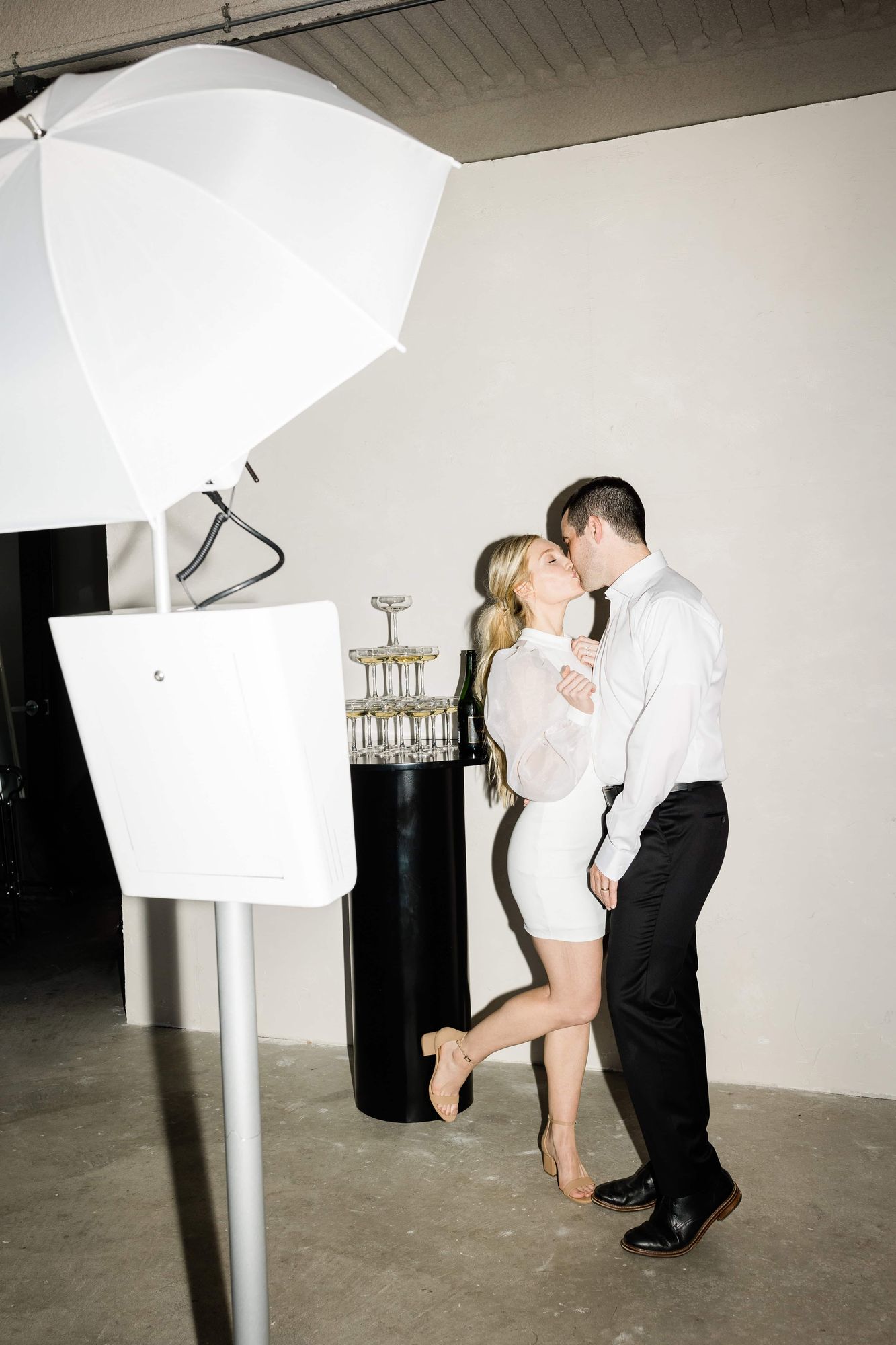 Couple kissing in front of the Ayer open-air photo booth