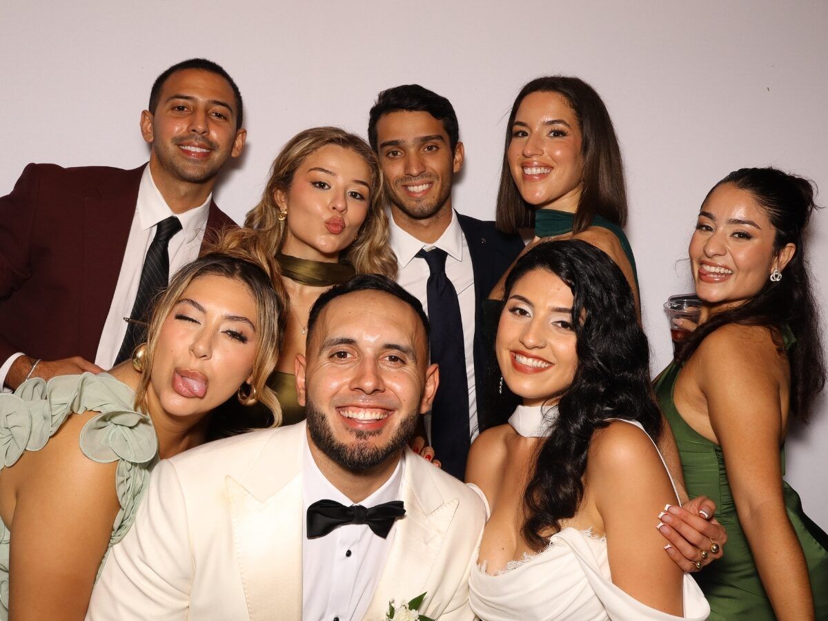 Friends posing together in the open-air photo booth